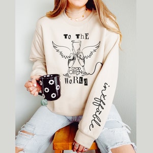 Good Omens Champagne Toast Sweatshirt: Ineffable Sleeve Detail