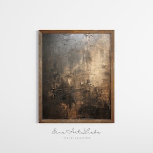 May include: A framed abstract painting with a dark brown and gold color scheme. The painting has a textured surface and is framed in a dark wood frame. The text "Eine Art Liebe" is printed below the painting.