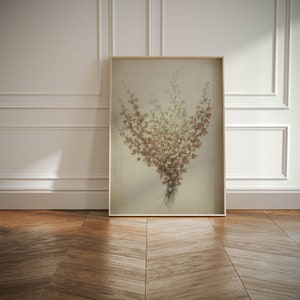 May include: A framed print of a bouquet of dried flowers in shades of brown, beige, and white. The flowers are arranged in a loose, natural style, and the background is a soft, muted beige.