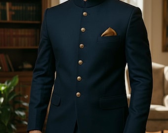 May include: A navy blue suit with a mandarin collar, featuring gold buttons and a matching pocket square. The tailored jacket has a classic design, suitable for formal occasions. The suit is made of a smooth fabric.