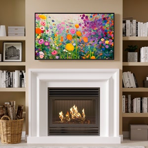 May include: A white fireplace with a black metal grate and a fire burning inside. The fireplace is surrounded by white trim and is set against a beige wall. There are bookshelves on either side of the fireplace, filled with books and decorative items.
