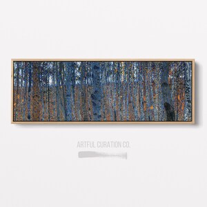 May include: A painting of a forest with tall, slender trees. The trees are a deep blue color, and the background is a lighter blue. The painting is framed in a light wood frame.