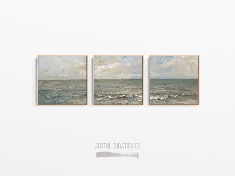 May include: Three framed seascape paintings. Each square canvas features a muted color palette of blues, grays, and beige, depicting the ocean under a cloudy sky. The paintings are displayed on a white wall.