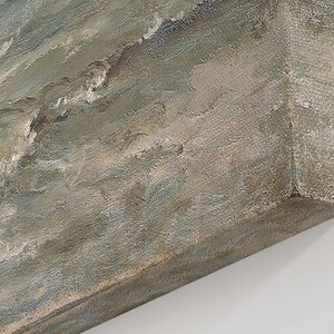 May include: An oil painting on canvas depicts a seascape with waves and a cloudy sky. The artwork uses a palette of muted blues, grays, and whites, with visible brushstrokes creating texture. The canvas is stretched over a wooden frame.