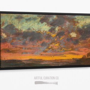 Puede incluir: Una pintura de paisaje rectangular en un marco negro que representa un atardecer con nubes azul oscuro y grises, luz naranja y amarilla vibrante cerca del horizonte y un primer plano oscuro. El texto ARTFUL CURATION CO. aparece debajo.