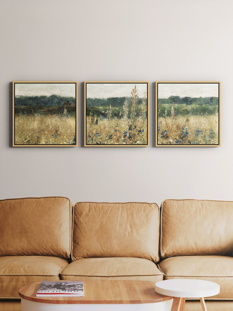 Pu&ograve; includere: Tre dipinti di paesaggi incorniciati con una tavolozza di colori tenui. I dipinti raffigurano un campo di erba alta e fiori selvatici con un bosco sullo sfondo.