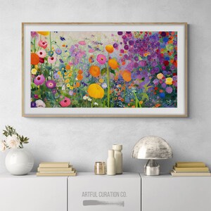 May include: A framed painting of a colorful flower garden with a variety of flowers in shades of pink, purple, yellow, and orange. The painting is set against a light background and is framed in a natural wood frame.