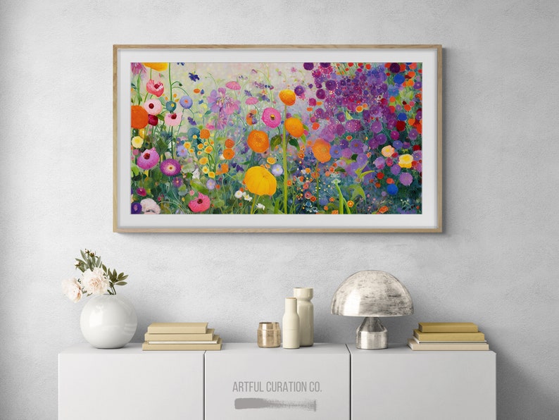 May include: A framed painting of a colorful flower garden with a variety of flowers in shades of pink, purple, yellow, and orange. The painting is set against a light background and is framed in a natural wood frame.