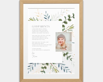 May include: A framed print with a watercolor background of green and blue leaves. The print features a poem about godparents and a photo of a baby. The poem reads "I need some special people to help me learn and grow. I know that it should be you. Mommy and Daddy told me so. They said that you will love me and be there should I call and always look out for me and pick me up if I fall. They said that you are a gift sent from God above. I know you will do your very best to give such care and love. I'd be so blessed if you would be my godparents! Love, Jalinn"