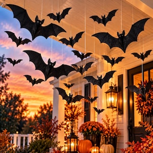 May include: A collection of black glittery bat decorations suspended from thin strings, featuring various sizes and wing positions. The bats are arranged in a scattered formation, creating a flying effect against a sunset sky background.