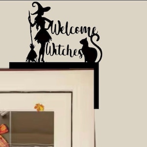 May include: Black metal Halloween decoration featuring a witch with a broom, a cat, and the words "Welcome Witches." The decoration is designed to be placed on a window frame or similar edge.