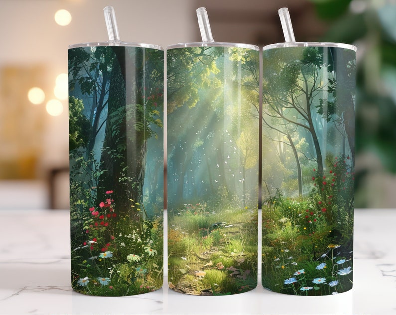 May include: Three stainless steel tumblers with a forest scene design. The tumblers feature a path through a lush green forest with sunlight streaming through the trees. The design includes flowers and foliage in shades of green, blue, and red.