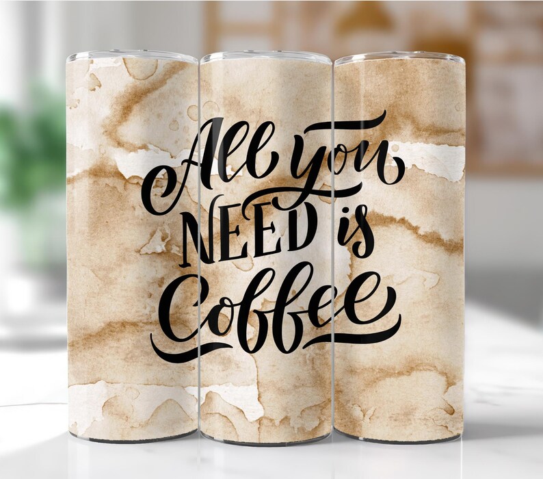 May include: Three stainless steel tumblers with a brown and white watercolor background. The tumblers have the text "All you need is coffee" in black cursive lettering.