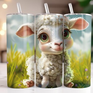 May include: A white lamb with a fluffy coat and big, brown eyes is featured on a stainless steel tumbler. The lamb is standing in a field of green grass with wildflowers.