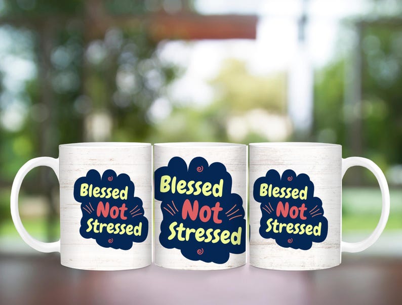 May include: Three white ceramic mugs with a woodgrain pattern. Each mug has a blue and yellow cloud with the text "Blessed Not Stressed" in pink and blue lettering.