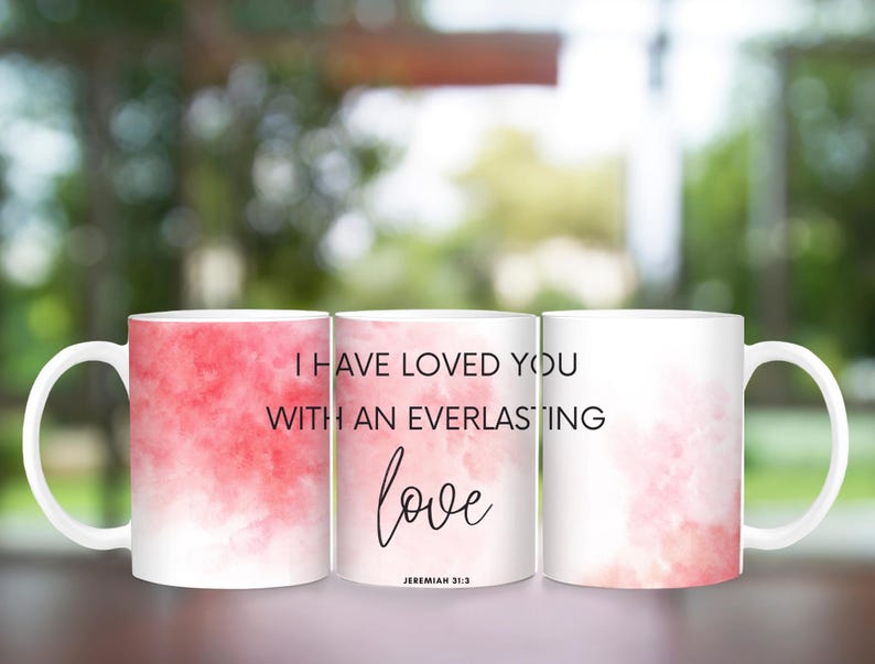 May include: Two white ceramic mugs with a pink watercolor background. The text on the mugs reads "I have loved you with an everlasting love Jeremiah 31:3".