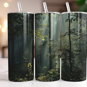 May include: Three stainless steel tumblers with a misty forest scene printed on them. The scene features tall trees and green foliage.