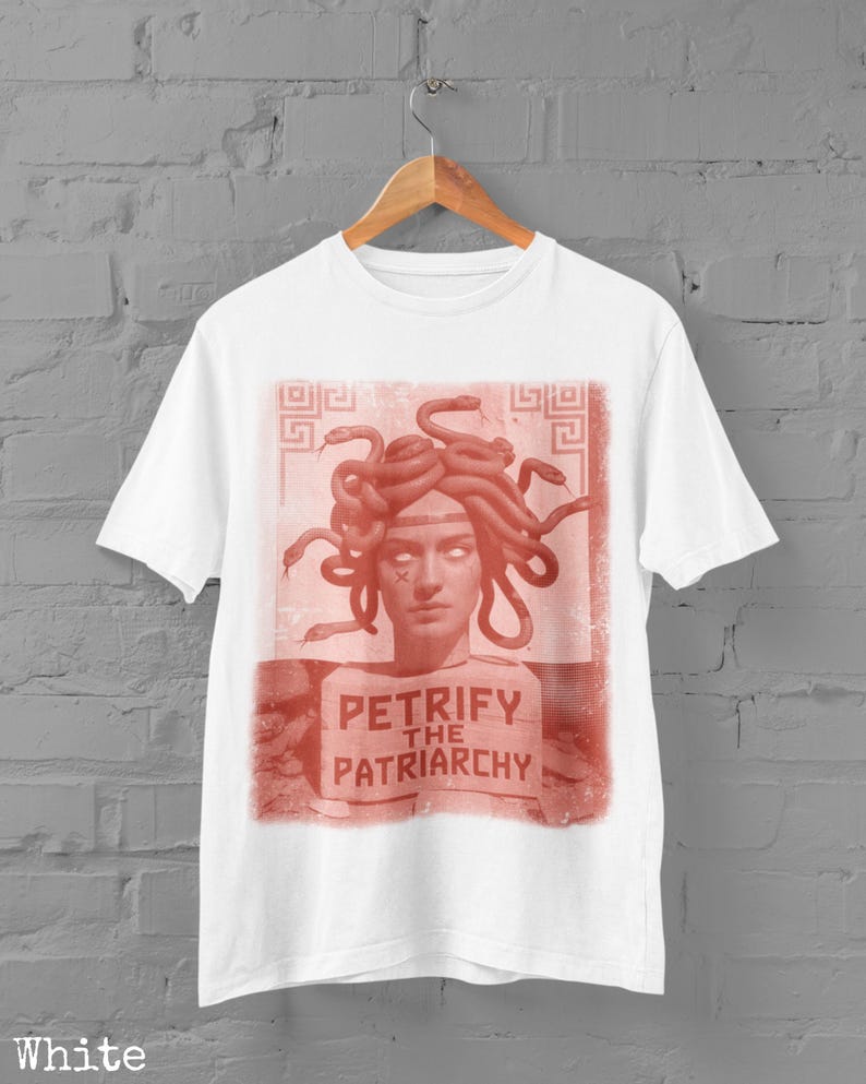 May include: White t-shirt with a red graphic depicting Medusa and the text "PETRIFY THE PATRIARCHY". The design is a striking statement on a classic tee, suitable for everyday wear.