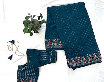 Può includere: Set salwar kameez indiano color teal. Il set include un top con strisce di paillettes verticali, un fondo abbinato e una dupatta. I bordi del fondo e della dupatta sono adornati da ricami floreali in rosa, verde e arancione.