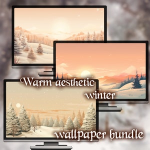 May include: Three computer monitors showing winter landscape wallpapers. The wallpapers depict snowy scenes with pine trees, mountains, and a warm sunset. Text on the bottom monitor reads "Warm aesthetic winter wallpaper bundle."
