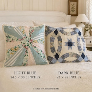 May include: Two square throw pillows on a bed. The left pillow features a light blue sunburst pattern with floral and striped fabric panels, measuring 24.5 x 30.5 inches. The right pillow has a dark blue double wedding ring quilt design, 22 x 28 inches.