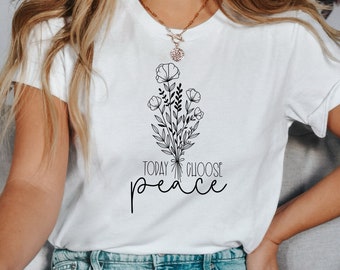 May include: White t-shirt with a black line drawing of a bouquet of flowers and the text "TODAY CHOOSE peace".