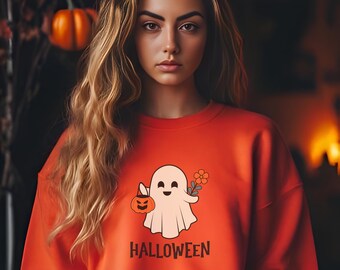 May include: Orange sweatshirt with a white ghost holding a pumpkin and a flower. The text "HALLOWEEN" is printed below the ghost.