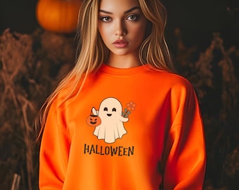 May include: Orange sweatshirt with a white ghost holding a pumpkin and a flower. The text "HALLOWEEN" is printed below the ghost.