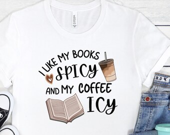 May include: White t-shirt with a graphic that says "I like my books spicy and my coffee icy". The graphic also includes a book, a heart, and a cup of coffee.