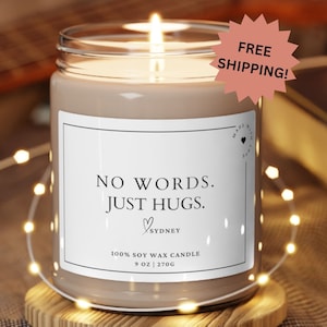 May include: A brown soy wax candle with a white label that reads "NO WORDS. JUST HUGS." and "SYDNEY". The candle is 9 ounces (270 grams) and is made with 100% soy wax.