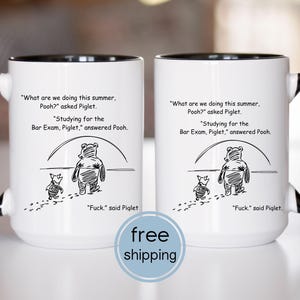May include: Two white ceramic mugs with black handles and rims. Each mug features a black and white illustration of Winnie the Pooh and Piglet, with text from the story. The text includes the phrase "Fuck," said Piglet.