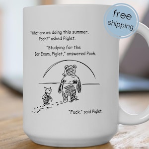 May include: White ceramic mug with a black and white cartoon illustration of Winnie the Pooh and Piglet. The mug features text from the cartoon, including the phrase "Fuck," said Piglet.