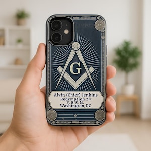 May include: A navy blue phone case featuring a Masonic symbol with the letter "G" at the center. The case has a vintage design with the text "Alvin (Chief) Jenkins Redemption 24 F. B.S. M. Washington, DC."