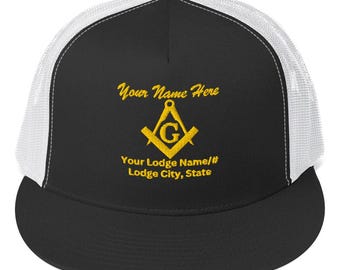 May include: Black and white trucker hat with a gold embroidered Masonic symbol and text that reads "Your Name Here", "Your Lodge Name/#", and "Lodge City, State".