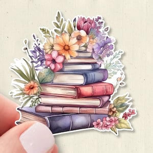 May include: A die-cut sticker featuring a stack of five books in shades of blue, red, and brown, topped with a vibrant arrangement of watercolor-style flowers including orange daisies, pink blossoms, and purple sprigs with green foliage.
