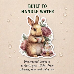 May include: A sticker featuring a brown rabbit holding a floral teacup, surrounded by pink roses, a teapot, and small cakes. The text reads BUILT TO HANDLE WATER and Waterproof laminate protects your sticker from splashes, rain, and daily use.