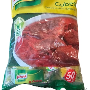 May include: A green and yellow packet of Knorr Cubes, a bouillon product. The packet shows a bowl of red meat in a sauce. The packet says "Taste the Knorr Difference" and "50 x 8g".