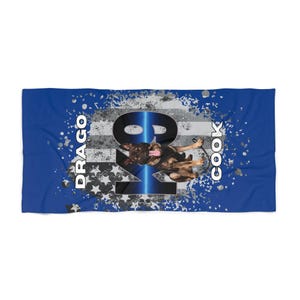 May include: A blue beach towel with a design featuring a German Shepherd dog, the text "DRAGO" and "COOK", and the numbers "K9". The design incorporates a distressed American flag motif with stars and stripes.