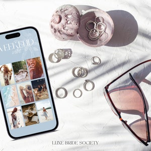 May include: A smartphone displaying a collage of photos with the text "Weekend vibe" on a white surface with sunglasses, jewelry, and a small decorative box.