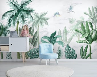 May include: A room with a tropical theme, featuring a white cabinet, a light blue chair, and a round white rug. The wall is decorated with a mural of green palm trees, large leaves, and flying birds against a marble background.