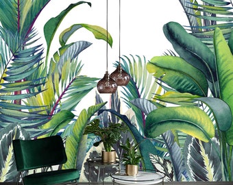 May include: A green velvet armchair with black metal legs sits in front of a wall mural featuring a watercolor painting of lush tropical foliage. Two hanging light fixtures with brown glass shades are visible in the background.