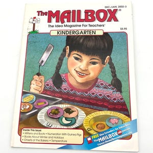 Pode incluir: A capa da revista "The MAILBOX" para professores, com uma criança sorrindo com tranças. O título da revista é em vermelho e branco, com "KINDERGARTEN" em verde. A capa inclui ilustrações de comida e animais. A edição é de dez/jan 2002-3.