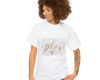 May include: White t-shirt with a gold foil graphic that says "glow" in a cursive font.
