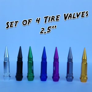 May include: Set of 4 tire valve stems in silver, black, green, blue, purple, gray, and gold. Each stem is 2.5 inches long.
