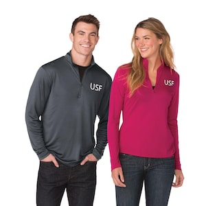 May include: Two people wearing long-sleeved shirts with a zippered neck. The shirts are gray and pink and both have the letters "USF" embroidered on the left chest.