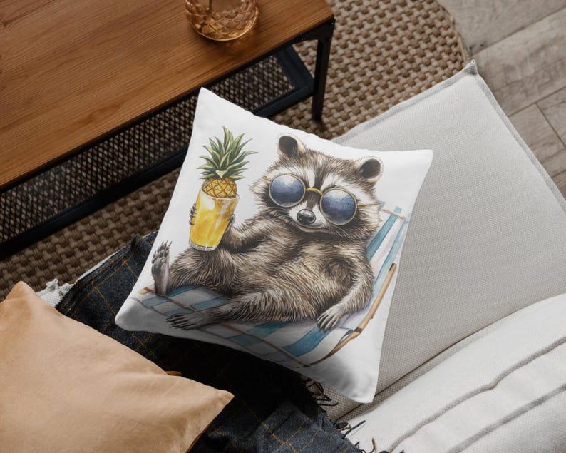 May include: A white throw pillow with a watercolor illustration of a raccoon wearing sunglasses and holding a pineapple juice. The raccoon is lounging on a beach chair.