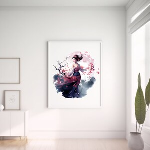 May include: A framed art print featuring a watercolor illustration of a woman in a flowing red and black dress, set against a backdrop of a pink moon and cherry blossoms. The artwork is displayed in a bright, minimalist room.