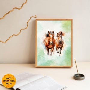Könnte beinhalten: Ein Aquarellbild von zwei braunen Pferden, die über ein grünes und blaues Feld laufen. Die Pferde befinden sich im Vordergrund des Bildes, das Feld im Hintergrund. Das Bild ist in einem Holzrahmen gerahmt.