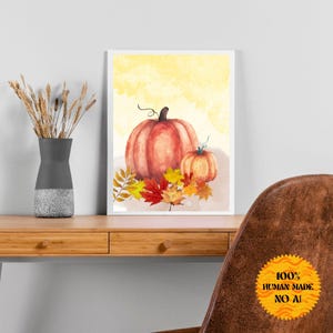 Könnte beinhalten: Aquarellmalerei von zwei Kürbissen mit Herbstblättern. Der größere Kürbis ist orange und der kleinere Kürbis ist hellorange. Die Blätter sind rot, orange und gelb.