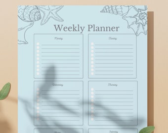 May include: A light blue weekly planner with a seashell theme. The planner has seven columns for each day of the week, with space for writing tasks or appointments. The planner is decorated with drawings of seashells and a starfish.